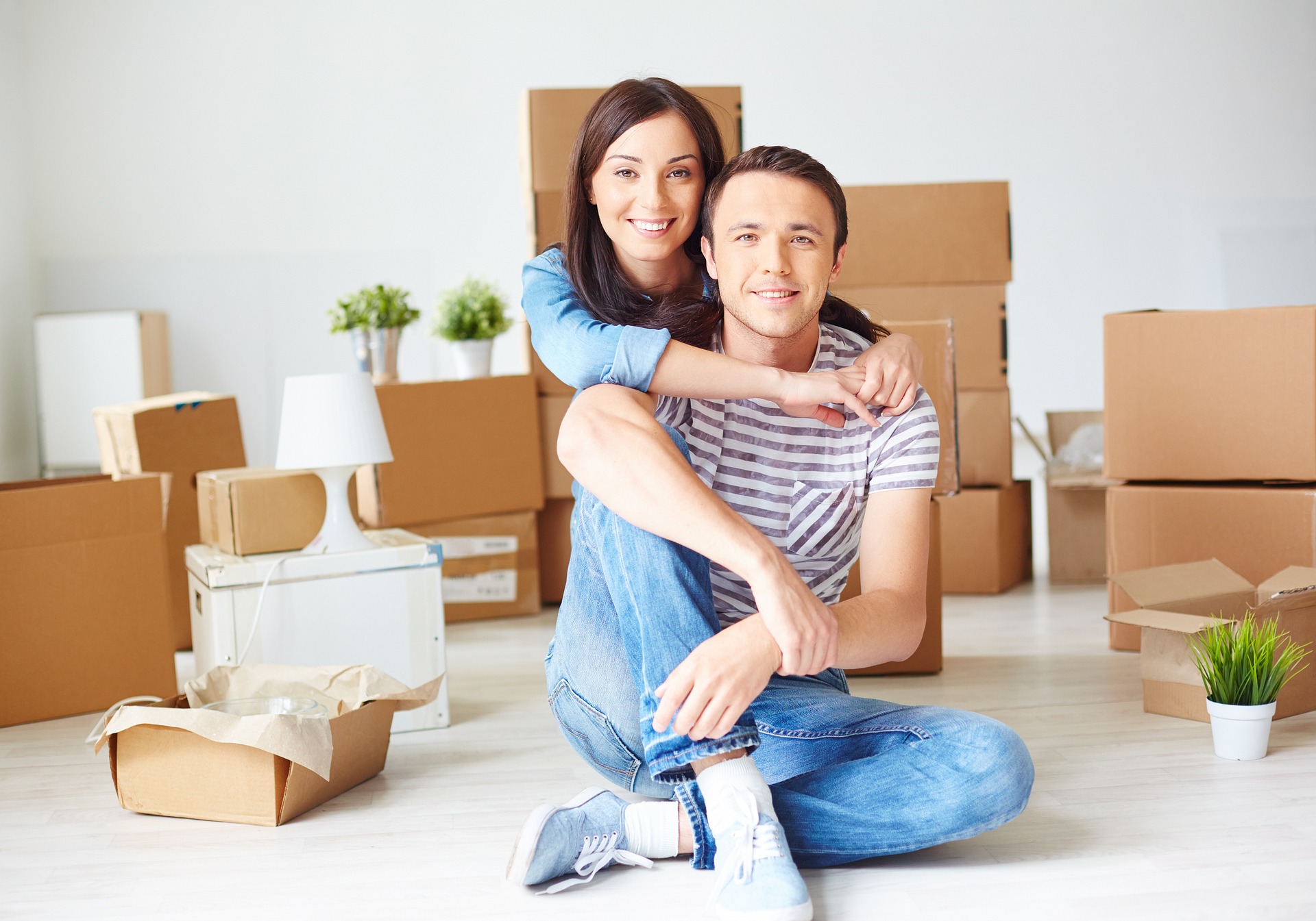 Couple sitting on the floor of their new home