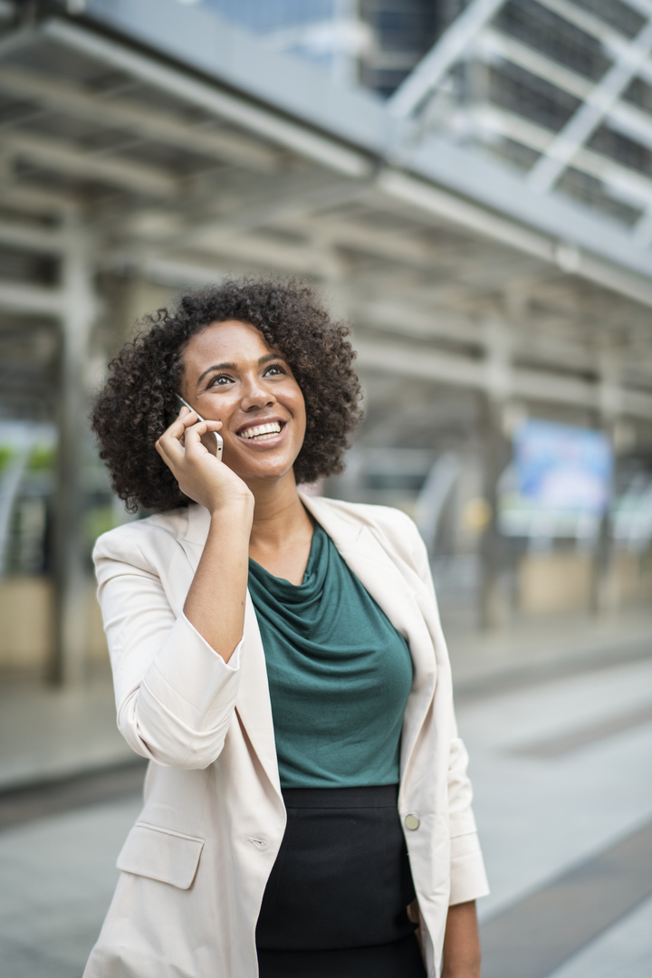 Girl smiling with talking with a mobile phone in the ear
