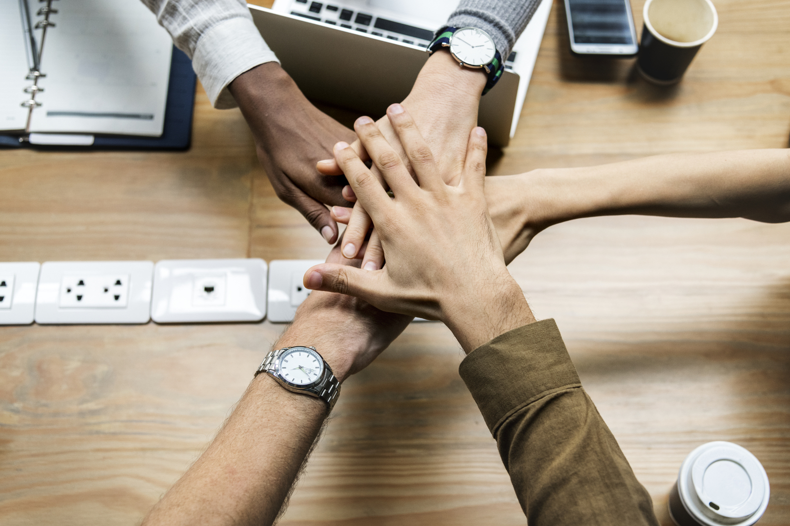 Hands of a work team on top of each other.
